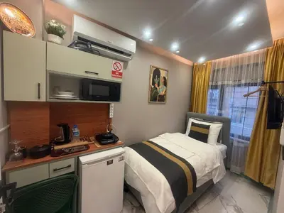 a small bedroom with a bed and a microwave at Cozy Studio Near Taksim Metro Station in Istanbul