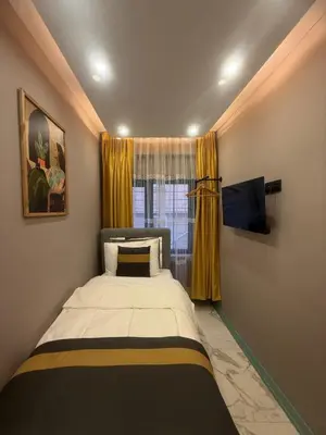 a small bedroom with a bed and a window at Cozy Studio Near Taksim Metro Station in Istanbul