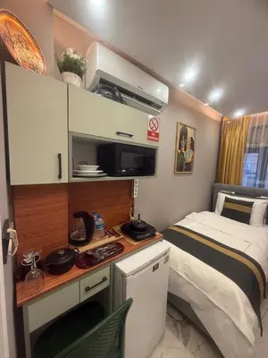 a small room with a bed and a desk in it at Cozy Studio Near Taksim Metro Station in Istanbul