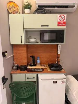 a small kitchen with a microwave and a stove at Cozy Studio Near Taksim Metro Station in Istanbul