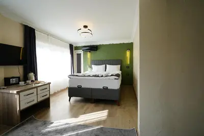 a bedroom with a bed and a desk and a window at the apart galata in Istanbul