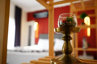 a vase with flowers in it sitting on a table at the apart galata in Istanbul
