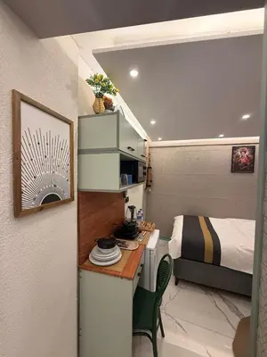 a room with a bed and a desk in a room at Modern Compact Studio Near Metro Station in Istanbul