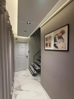 a hallway with a staircase and a picture on the wall at Modern Compact Studio Near Metro Station in Istanbul