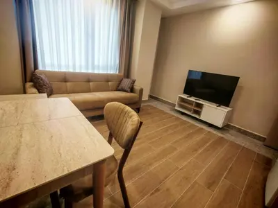 a living room with a couch and a television at Suitev in Arnavutköy