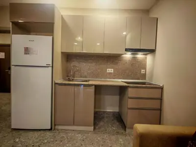 a kitchen with a white refrigerator and a sink at Suitev in Arnavutköy