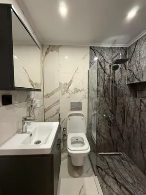 a bathroom with a sink and a toilet and a shower at Warm cozy studio 8 min by metro station in Istanbul