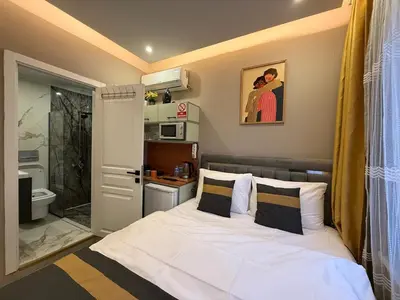 a small bedroom with a bed and a bathroom at Warm cozy studio 8 min by metro station in Istanbul