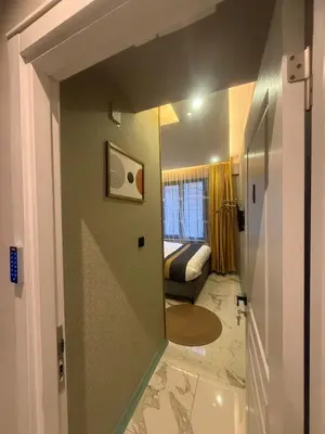 a room with a room with a bed and a hallway at Warm cozy studio 8 min by metro station in Istanbul