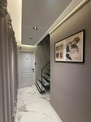 a hallway with a staircase and a picture on the wall at cozy studio apt near to taksim square in Istanbul