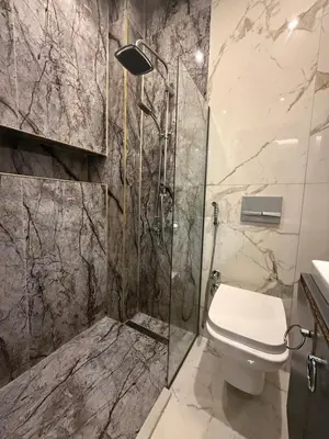 a bathroom with a toilet and a glass shower at cozy studio apt near to taksim square in Istanbul