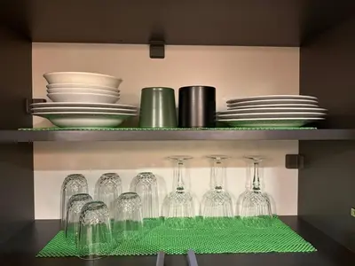 a shelf with wine glasses and plates and dishes at Cozy duplex with a private terrace near the metro in Istanbul