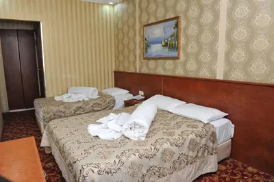 two beds in a hotel room with towels on them at Turvan Hotel in Istanbul