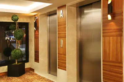 a hallway with a elevator and a plant at Mard-inn Hotel in Istanbul