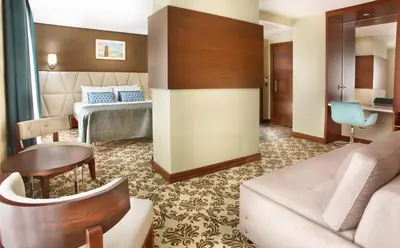a hotel room with a couch and a table at Mard-inn Hotel in Istanbul
