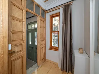 a hallway with a green door and a window at acme studio in Istanbul