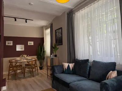 a living room with a couch and a table at Stylish Apartment 3 Min to Metro in Istanbul