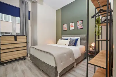 a bedroom with a large bed and a staircase at 2BR Modern Flat in Nişantaşı 3 Min to Metro Full AC in Istanbul