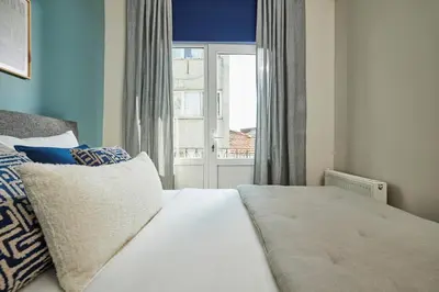 a bedroom with a white bed with a window at Central Nişantaşı Stay 2BR Flat AC in All Rooms in Istanbul