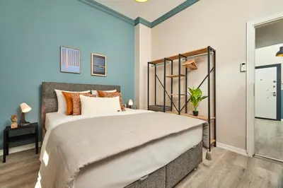 a bedroom with a large bed with orange pillows at Central Nişantaşı Stay 2BR Flat AC in All Rooms in Istanbul