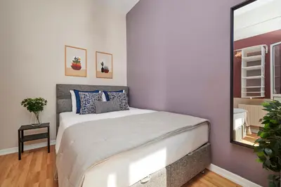 a bedroom with a large bed and a mirror at Comfortable 2BR Flat in Nişantaşı Near Metro in Istanbul