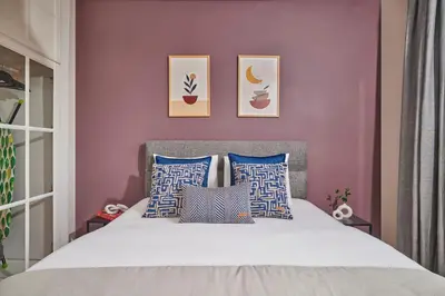 a bedroom with a bed with blue and white pillows at Modern 2BR in Nisantasi Area Balconies & AC in Istanbul