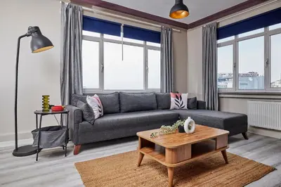 a living room with a couch and a table at Modern 2BR in Nisantasi Area Balconies & AC in Istanbul