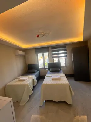a room with two beds and a couch in it at rema house in Gemlik