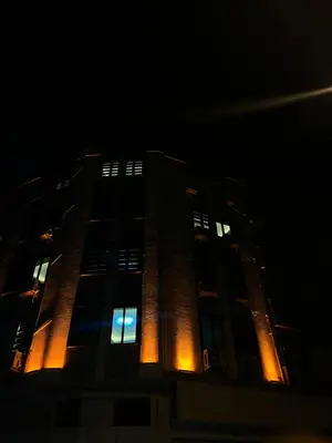 a tall building at night with its lights on at rema house in Gemlik