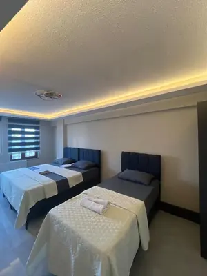 a bedroom with two beds and a window at rema house in Gemlik
