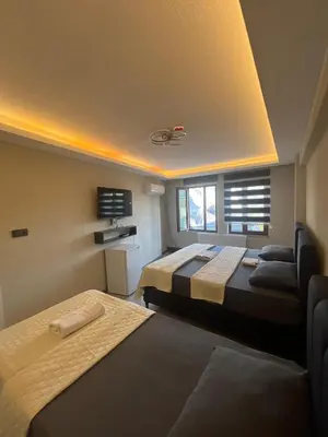 a room with two beds and a couch at rema house in Gemlik