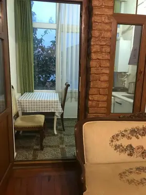 a room with a table and a chair and a mirror at Suite with a kitchen near istiklal street in Istanbul