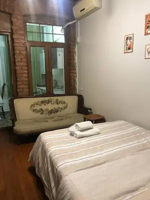 a bedroom with a bed with towels on it at Suite with a kitchen near istiklal street in Istanbul