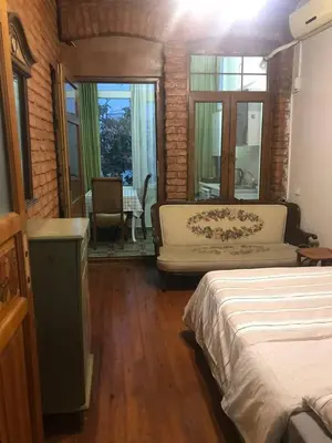 a bedroom with a bed and a couch and a table at Suite with a kitchen near istiklal street in Istanbul