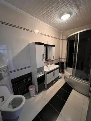 a bathroom with a toilet and a sink and a tub at apart housee in Istanbul