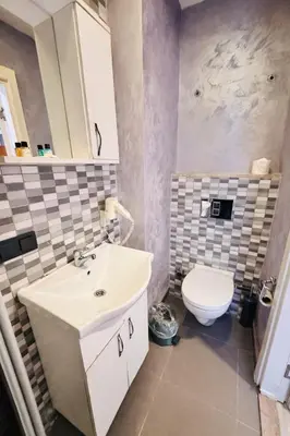 a bathroom with a white sink and a toilet at Heart of Pera by Allyon Suite Hotel in Istanbul