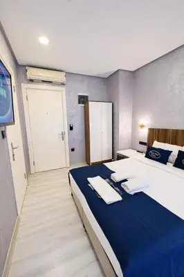 a bedroom with a large bed with towels on it at Heart of Pera by Allyon Suite Hotel in Istanbul