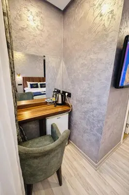 a room with a desk and a chair and a bed at Heart of Pera by Allyon Suite Hotel in Istanbul