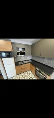 an empty kitchen with a stove and a refrigerator at nişanesi sita in Istanbul
