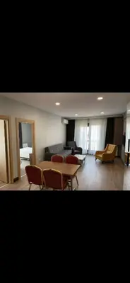 a living room with a table and chairs and a couch at nişanesi sita in Istanbul