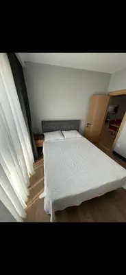 a bedroom with a bed with a white blanket on it at nişanesi sita in Istanbul