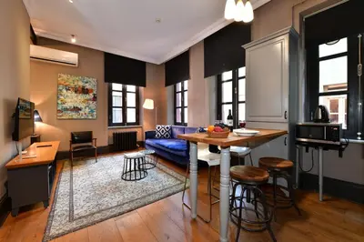 a living room with a blue couch and a table at Balkon Residence in Istanbul
