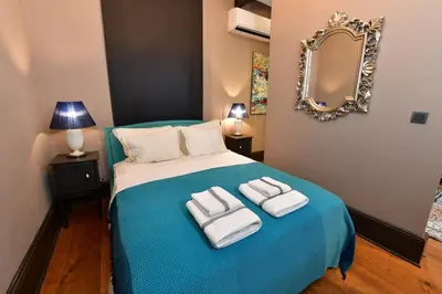 a bedroom with a blue bed with towels on it at Balkon Residence in Istanbul