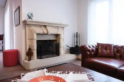 a living room with a couch and a fireplace at Terrazzo Sapanca - Isıtmalı Havuzlu Villa Süha Fazlı in Sapanca