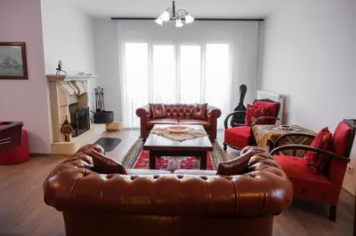 a living room with a leather couch and a table at Terrazzo Sapanca - Isıtmalı Havuzlu Villa Süha Fazlı in Sapanca