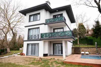 a white house with a balcony on top of it at Terrazzo Sapanca - Isıtmalı Havuzlu Villa Süha Fazlı in Sapanca