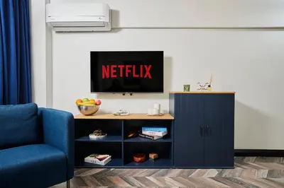a tv on top of a cabinet in a living room at Stunning Combo Flat in Nisantasi in Istanbul