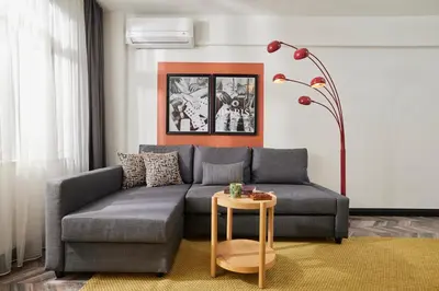a living room with a gray couch and a table at Bright & Modern 2-Bedroom Flat Near Metro in Istanbul