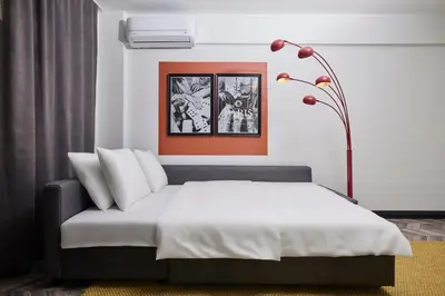 a bedroom with a bed and a lamp at Bright & Modern 2-Bedroom Flat Near Metro in Istanbul