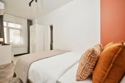 a bedroom with a white bed and a window at Bright & Modern 2-Bedroom Flat Near Metro in Istanbul